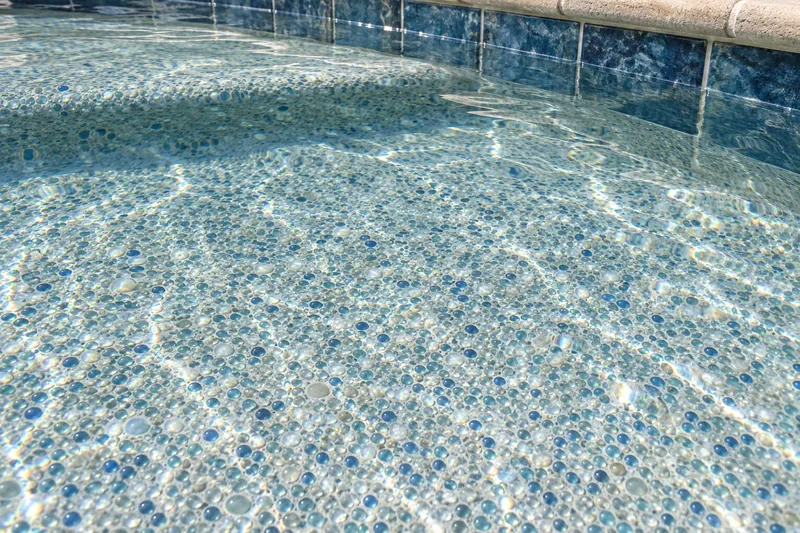 Glass bead pool finish in pale aqua and blue under clear water