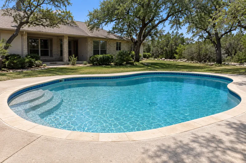 Backyard pool with a pebble and glass bead finish in bright aqua water