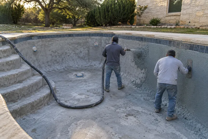 Quartz plaster shot from a hose nozzle onto a bare pool wall